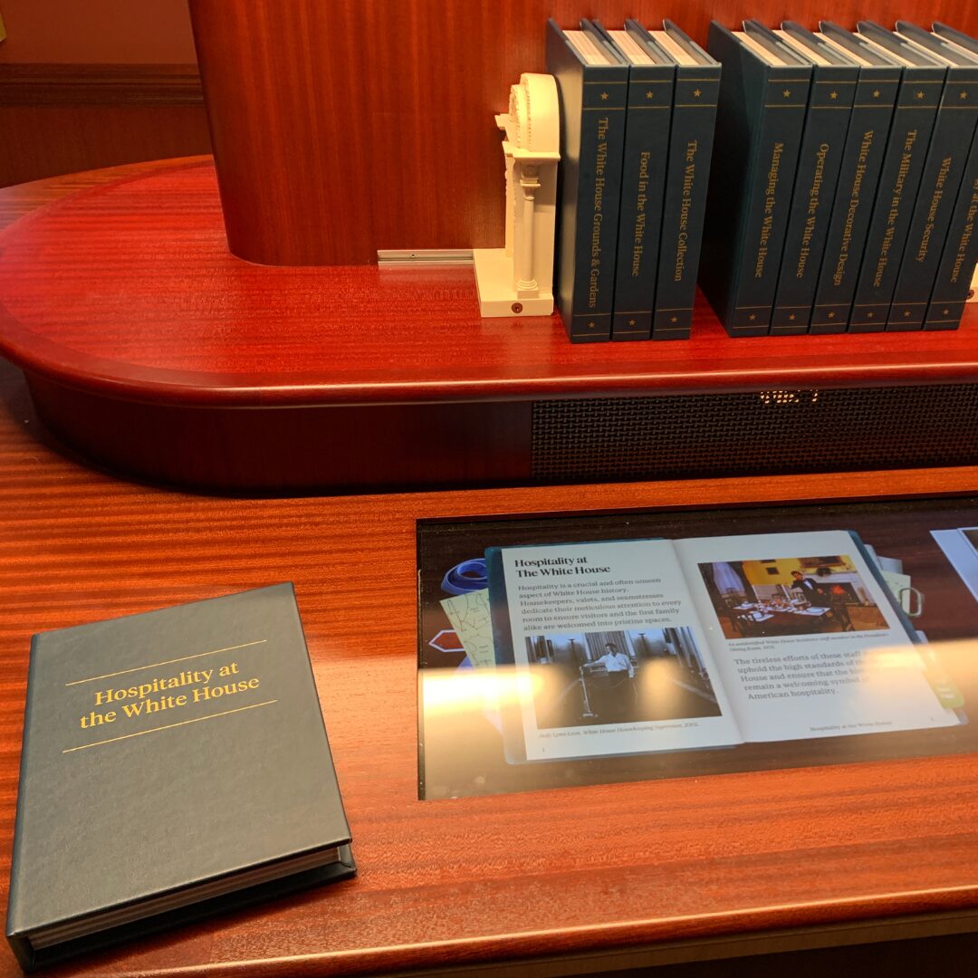 Book that shows 'hospitality at the white house' along a screen